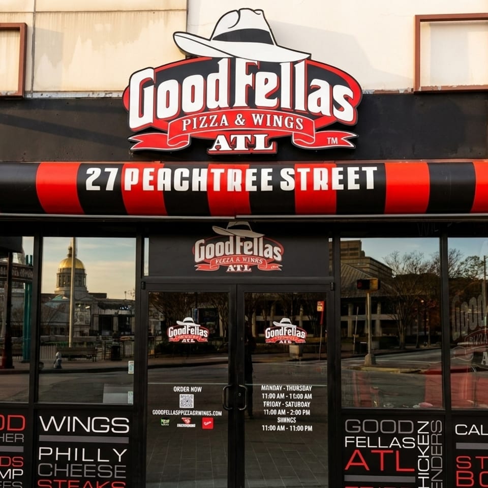 Goodfellas Pizza & Wings storefront at 27 Peachtree Street, with menu items visible on the windows.